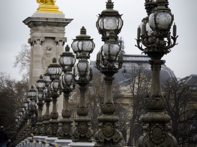 some lamps along an arched bridge